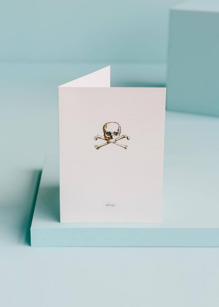 greeting card with vintage illustration of a skull and cross bones. inscription reads "ahoy"